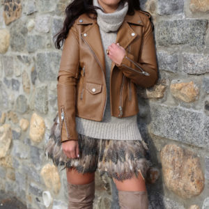 Blogger Sarah Lindner of The House of Sequins wearing alice + Olivia cina feather skirt, blankNYC easy rider brown faux leather moto jacket and steve madden over the knee boots
