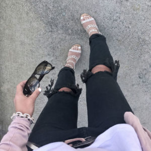 Blogger Sarah Lindner of The House of Sequins wearing one teaspoon jeans and white free people tank top for spring talking about ​Mercury In Retrograde.
