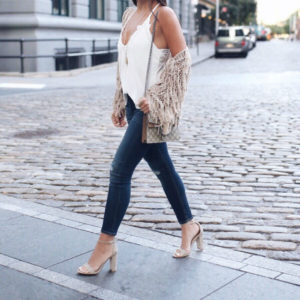 Blogger Sarah Lindner of The house of sequins wearing amuse society Chelsea Fringe Sweater, rag and bone skinny jeans and free people slinky tank