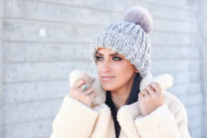 Blogger Sarah Lindner of The House of sequins wearing free people Teddy Peacoat and free people Happy Trails Pom Beanie