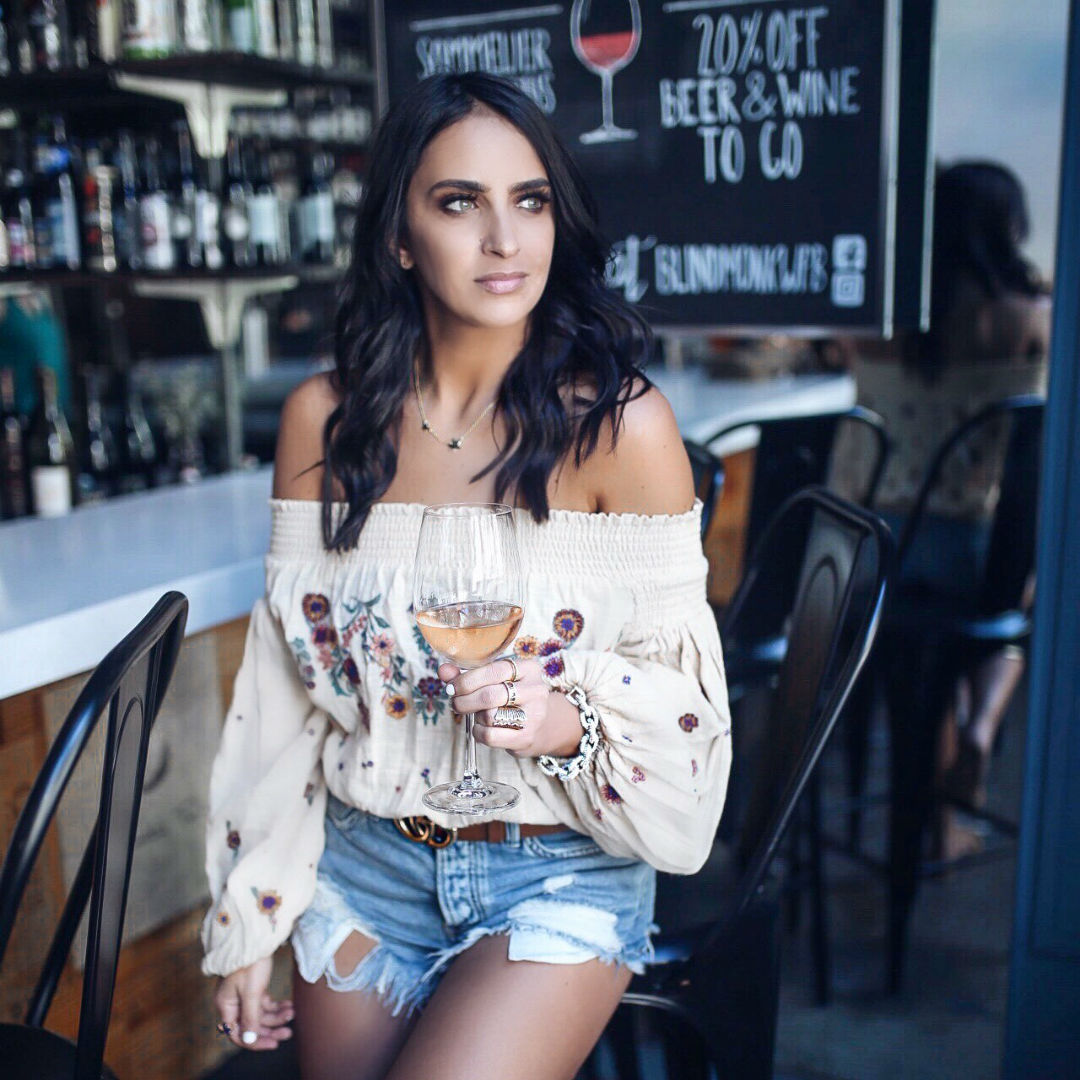 Blogger Sarah Lindner of the house of sequins wearing Free People Saachi Smocked Top and free people good vibration denim shorts