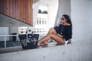 Blogger Sarah Lindner of The House of Sequins wearing Chelsea28 black off the shoulder top and rebecca minkoff black off duty tote bag