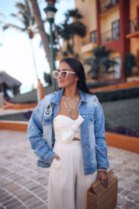 Blogger Sarah Lindner of The House of Sequins wearing Free People Sunday Funday Denim Trucker Jacket and ASTR the label mara jumpsuit