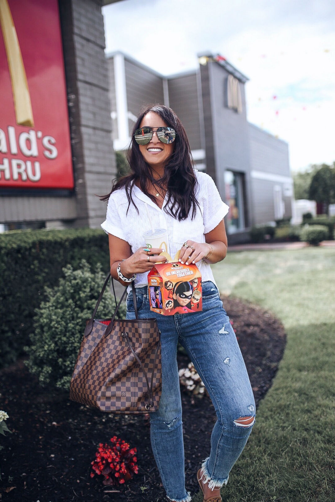 Blogger Sarah Lindner of The House of Sequins wearing Bella Dahl Eyelet-Stripe Shirt, express distressed skinny jeans, tory burch miller sandals, Louis Vuitton neverfull gm tote bag