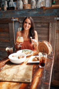 Blogger Sarah Lindner of The House of Sequins wearing Free People Heat Wave Tunic Dress that is in the color Terracotta