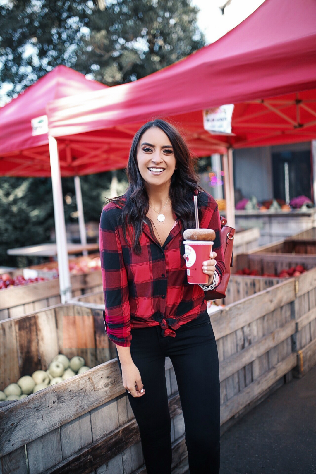 blogger Sarah Lindner of The House of Sequins wearing black Levi’s 711 Skinny Jeans and Plaid Tie Front Elbow Sleeve Blouse from Walmart. What to wear to a farmers market.