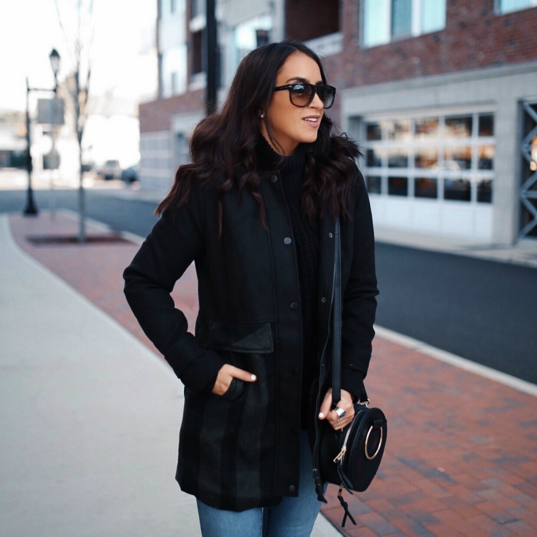 Blogger Sarah Lindner of The House of Sequins wearing Jason Maxwell Long Faux Wool Jacket with a Hood, Metallic Sky Crossbody, Time And Tru Hiker Boots in black, and Poof! Cable Knit Turtle Neck Long Sleeve Sweater