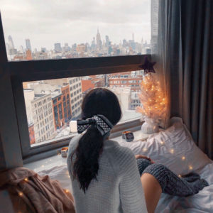 Blogger Sarah Lindner of The House of Sequins wearing loft over sized sweater, ugg cable knit knee high socks and henri bendel silk scarf. What to wear to NYC in the winter or Christmas time.
