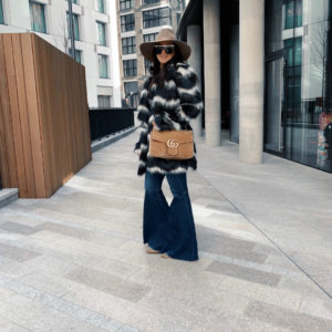 blogger sarah Lindner of the house of sequins wearing Show Me Your Mumu Raymond Jacket, Gucci GG Marmont velvet medium shoulder bag, Quay Hindsight with Gold Bar Sunglasses, Free People Just Float On Flare Jeans
