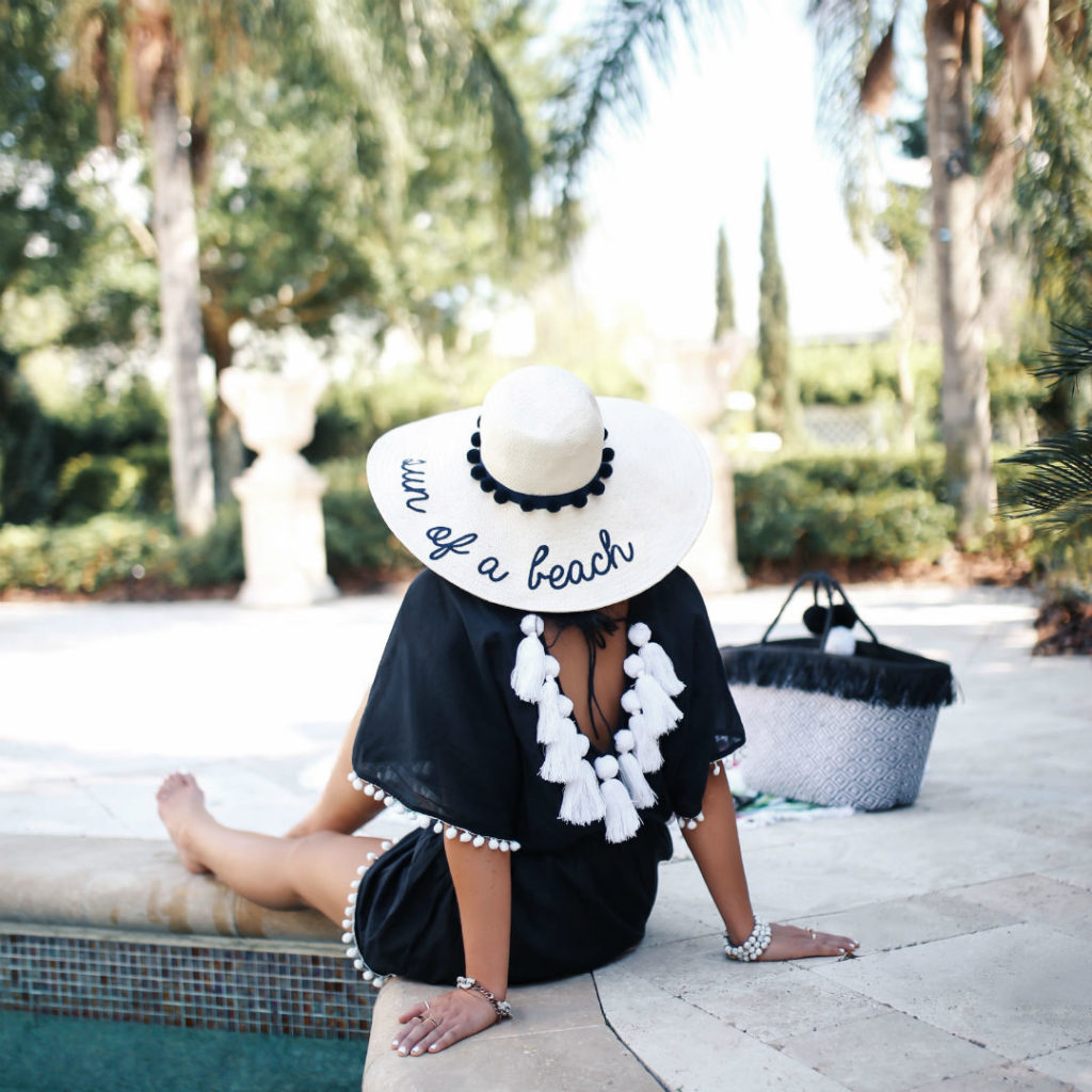 Blogger Sarah Lindner of The House of Sequins wearing Mud Pie Kiara Tassel Cover up, Mud Pie Sun of A Beach Sun Hat and Mud Pie Raffia Tote