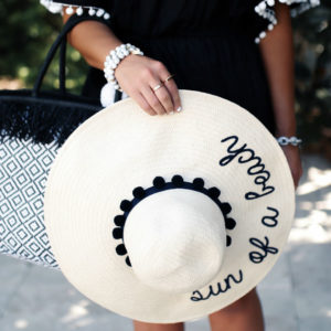Blogger Sarah Lindner of The House of Sequins wearing Mud Pie Kiara Tassel Cover up, Mud Pie Sun of A Beach Sun Hat and Mud Pie Raffia Tote
