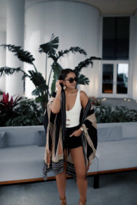 Blogger Sarah Lindner of The House of Sequins wearing montce Kim One-Piece Swimsuit with Belt, Marc Fisher wedge sandals, must have beach kimono from amazon