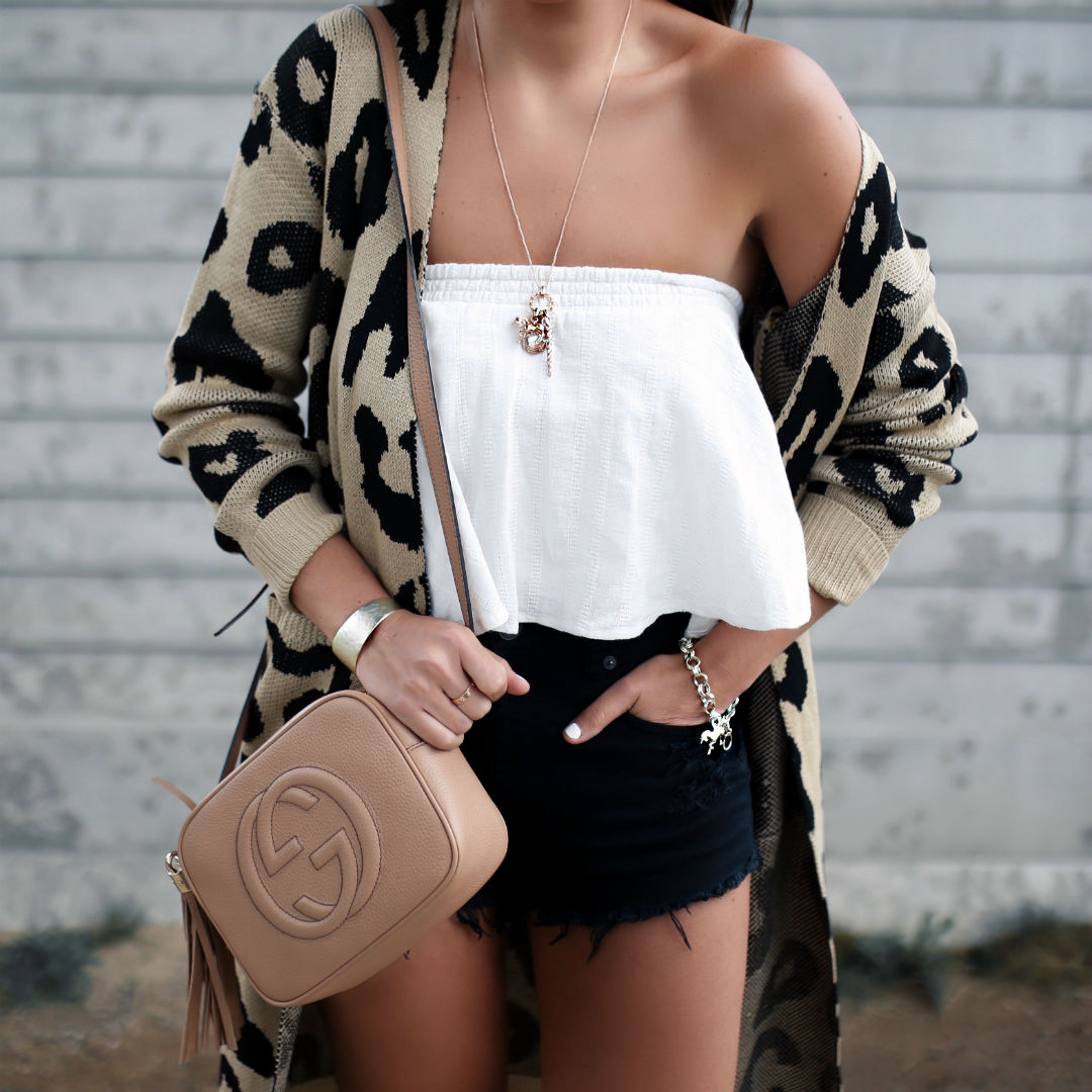 Blogger, Sarah LIndner of The House Of Sequins wearing a Kendra Scott charm necklace and charm bracelet 