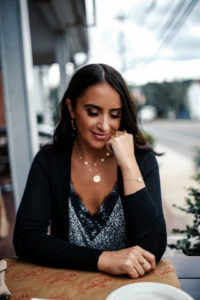 Blogger, Sarah Lindner of The House Of Sequins wearing a lace cami and a black cardigan