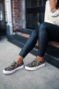 Blogger Sarah Lindner of The House of Sequins wearing Spanx Faux Leather leggings and Leopard steve madden gills slip on sneakers