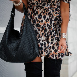 Blogger Sarah Lindner of The House of Sequins wearing J.ING Wildcat Leopard Print Dress, Black over the knee boots and black bottega Veneta bag