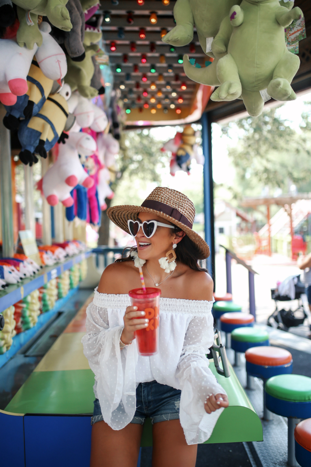 Blogger Sarah Lindner of The House of Sequins wearing white Off Shoulder Tops Polka Dot from amazon prime, BlankNYC shorts, Brixton Joanna Hat. What to wear to an amusement park