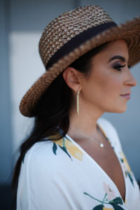 Blogger Sarah lindner of The House of Sequins wearing Rails Athena Wrap Top and Rails Etienne lemon wrap skirt and kendra scott gold hoop earrings