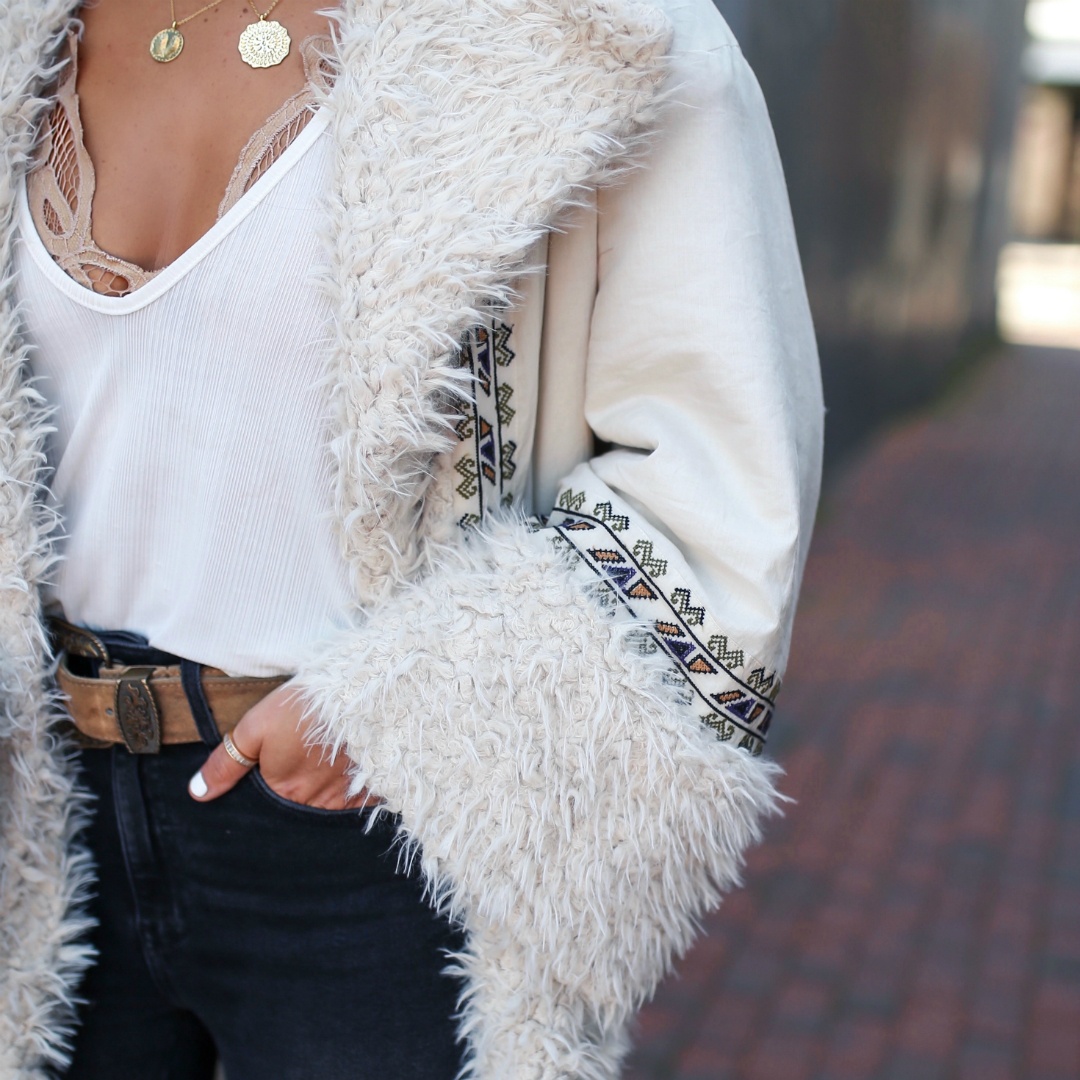 Blogger Sarah Lindner of The House of Sequins wearing Free People One Oslo Parka and Raw High-Rise Jegging