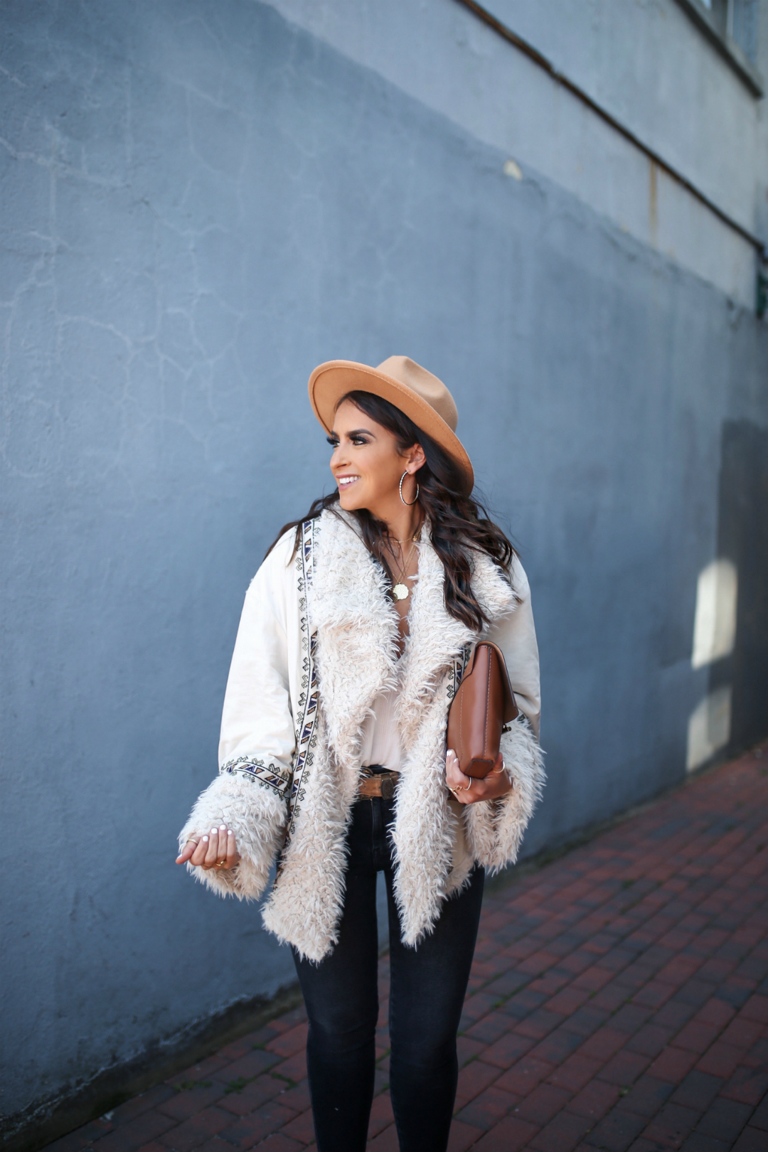 Blogger Sarah Lindner of The House of Sequins wearing Free People One Oslo Parka and Raw High-Rise Jegging
