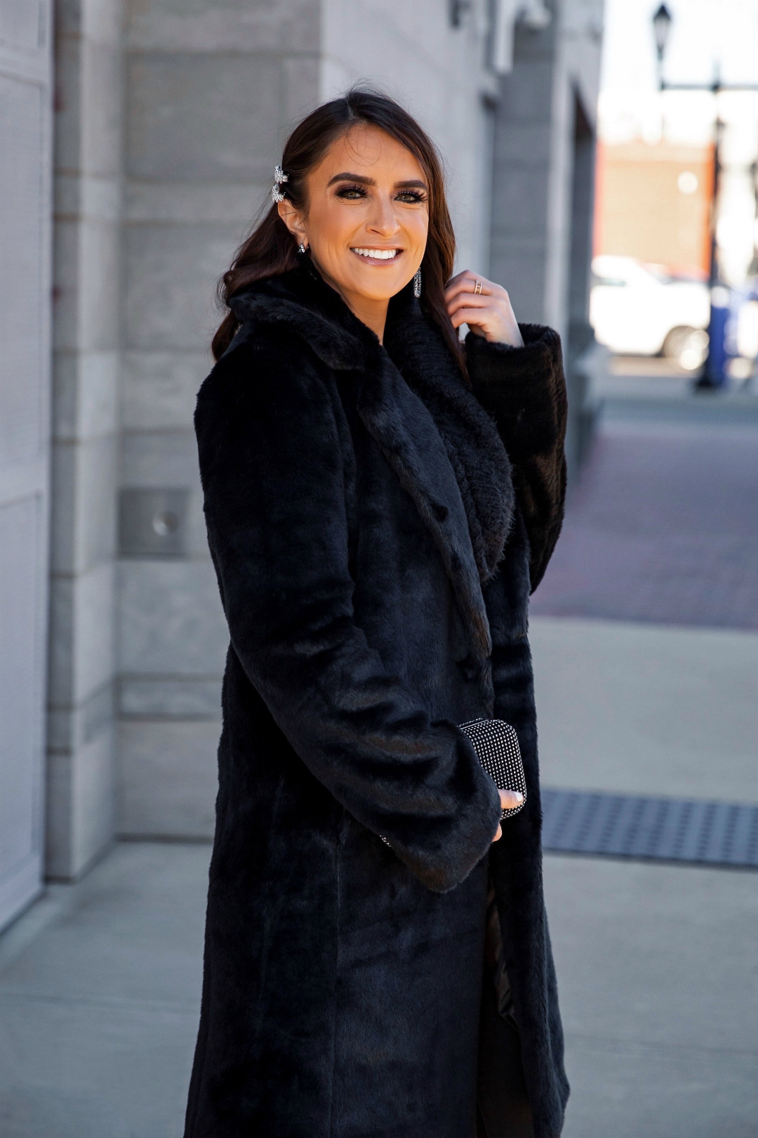 Blogger Sarah Lindner of The House of Sequins wearing faux fur coat and cozy feather pullover sweater from Express.