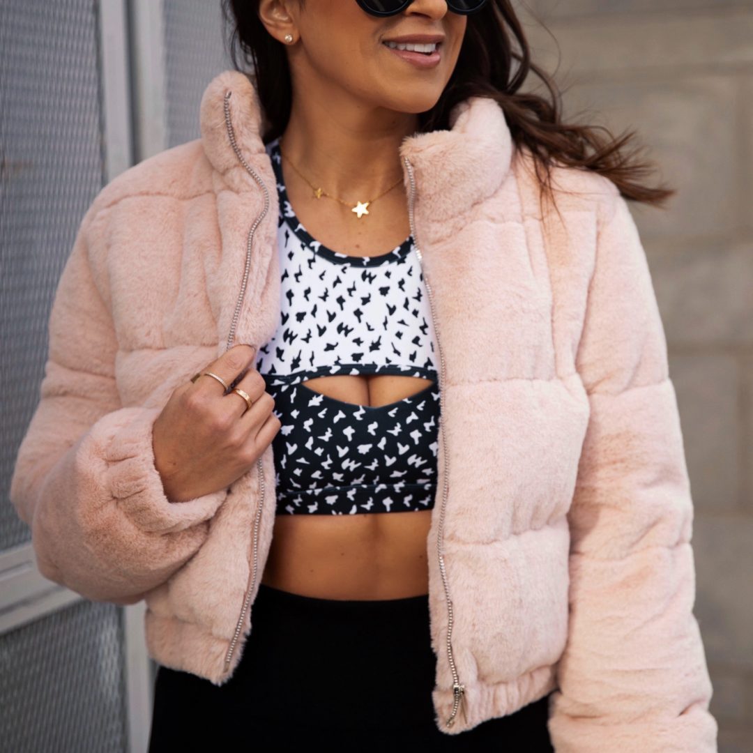 Blogger Sarah Lindner from The House of Sequins wearing a a blush pink puffer and leggings from Walmart