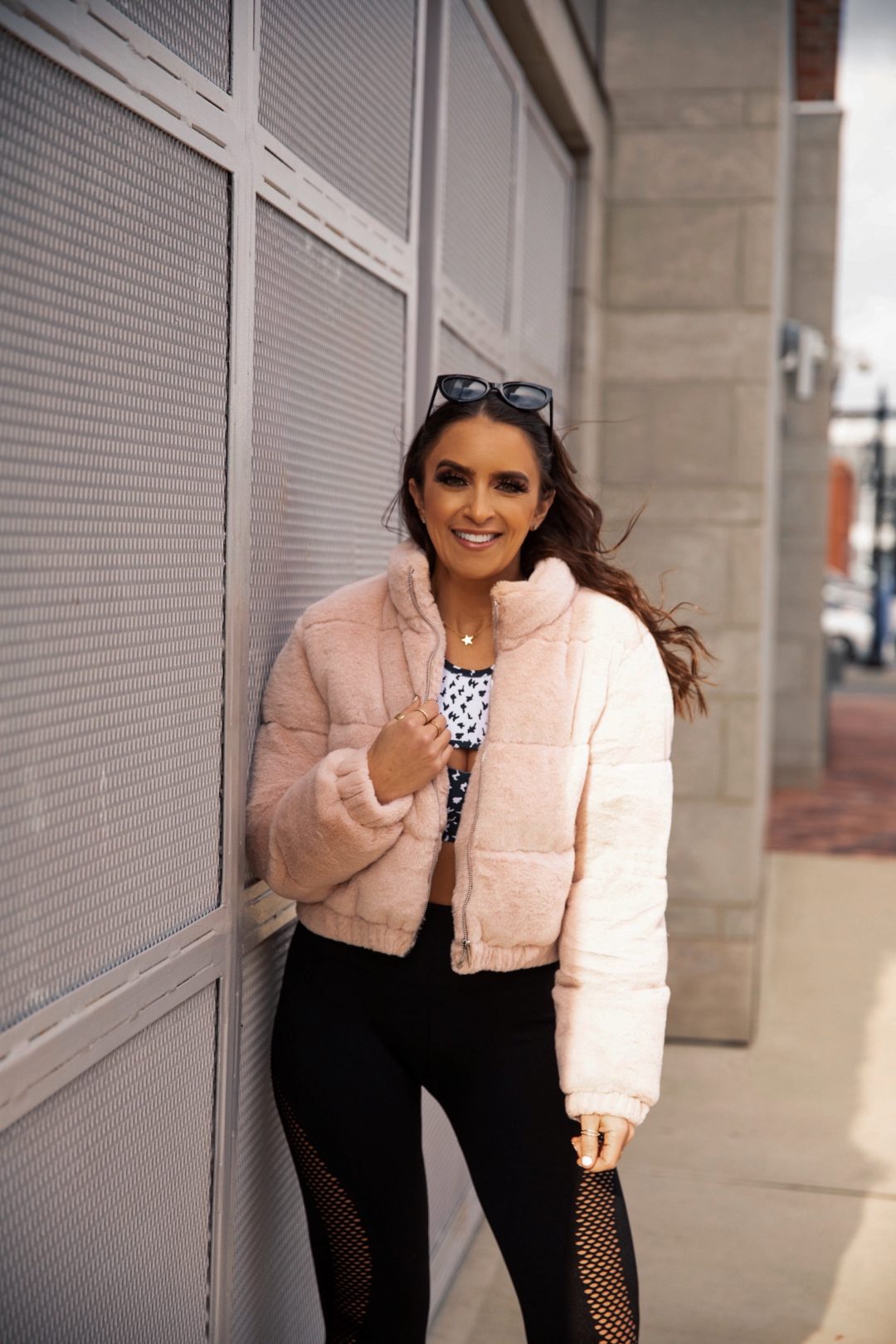 Blogger Sarah Lindner from The House of Sequins wearing a a blush pink puffer and leggings from Walmart