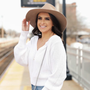 Blogger Sarah Lindner of The house of Sequins wearing white cut out sweater from express