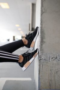 Blogger Sarah Lindner of The House of Sequins styling Adidas NMD R1 sneakers and athletic wear.