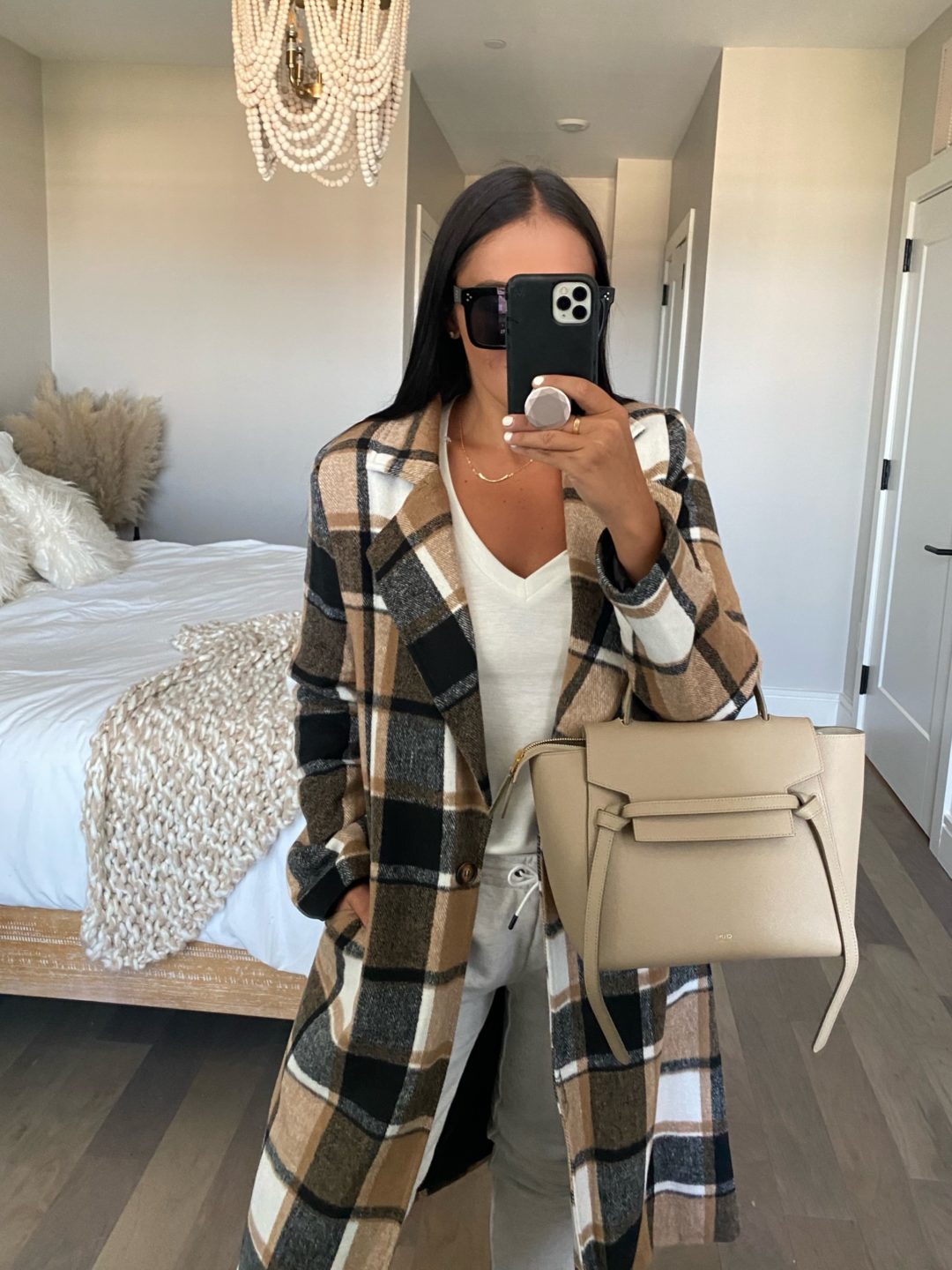 Blogger Sarah Lindner of The House of Sequins styling a plaid coat.